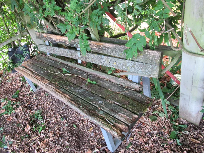 le premier banc de l'aire de jeux pour enfants, en très mauvais état